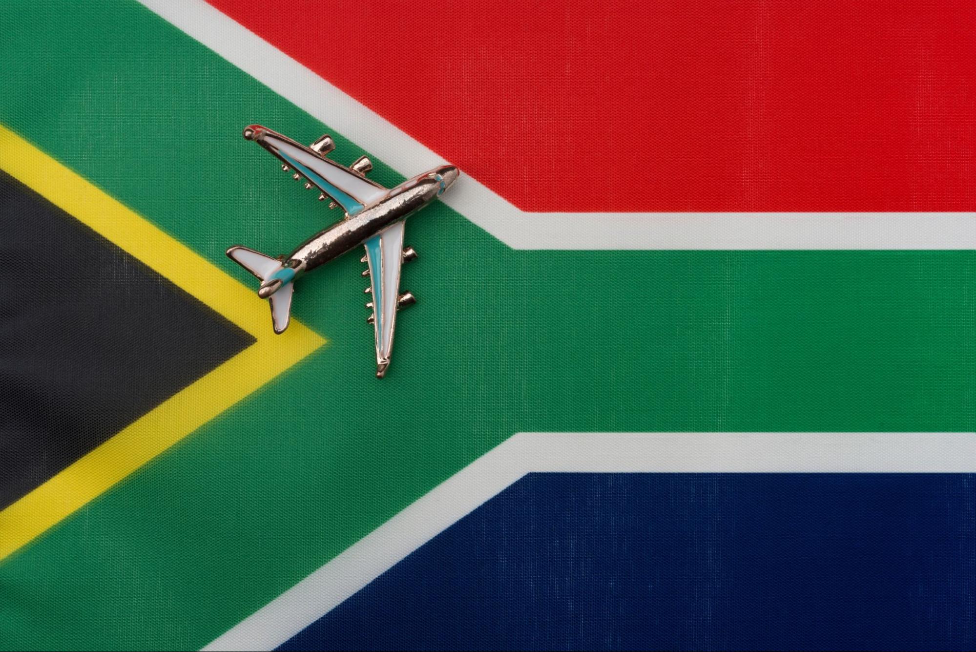 Airplane over South African flag travel