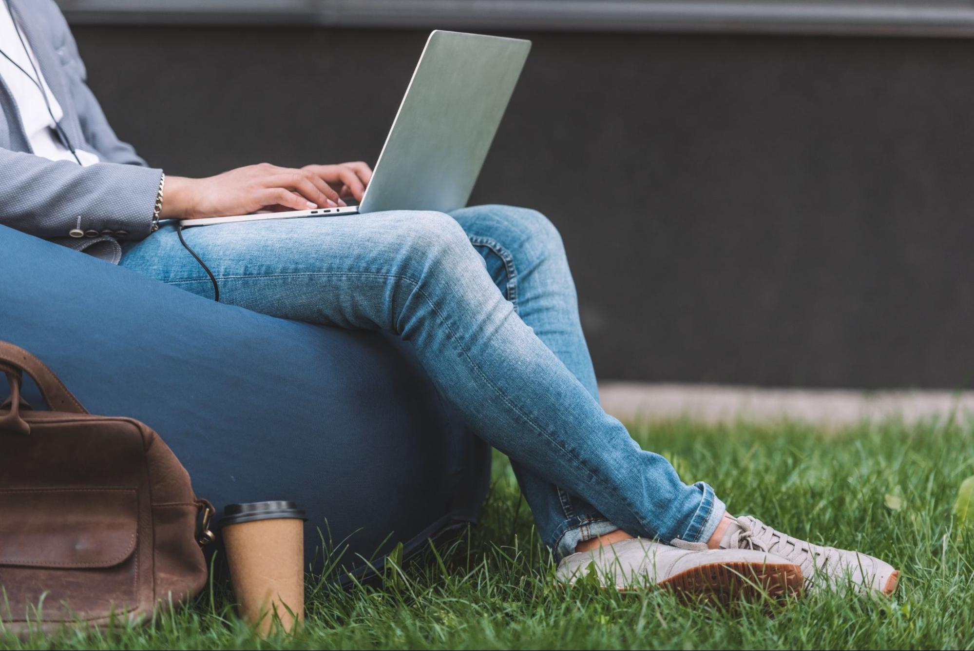 Teleworker using laptop while sitting on bean bag chair